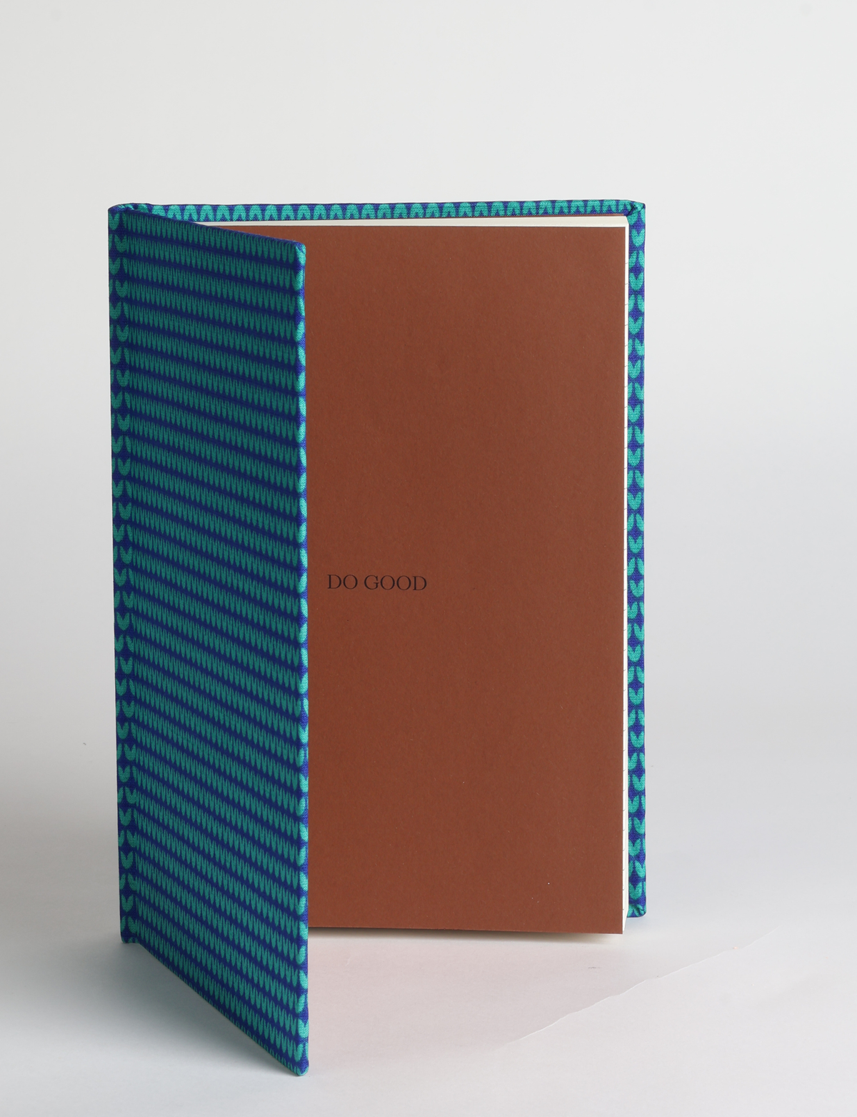 A5 hard cover notebook featuring the DO GOOD message, durable hardbound cover, ruled inner pages, printed endpapers and a lay-flat design.