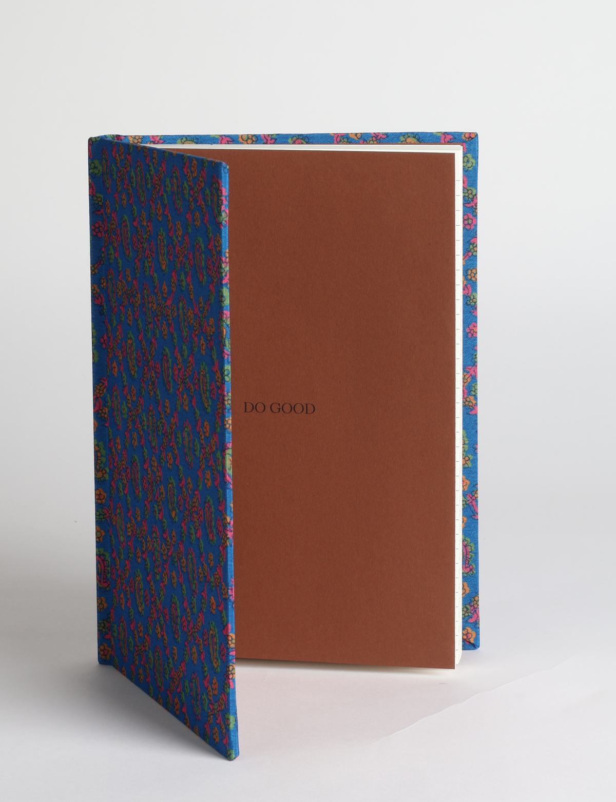 A5 hard cover notebook featuring the DO GOOD message, durable hardbound cover, ruled inner pages, printed endpapers and a lay-flat design.