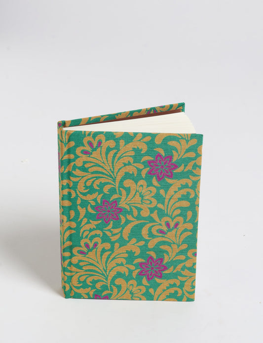 Indulge your creative spirit with our A6 hardcover notebook – a blend of sustainability and style. Made with 100% recycled paper and adorned with pre-loved sari fabric, this eco-conscious notebook encourages mindful note-taking and resonates with the principles of eco-friendly fashion.