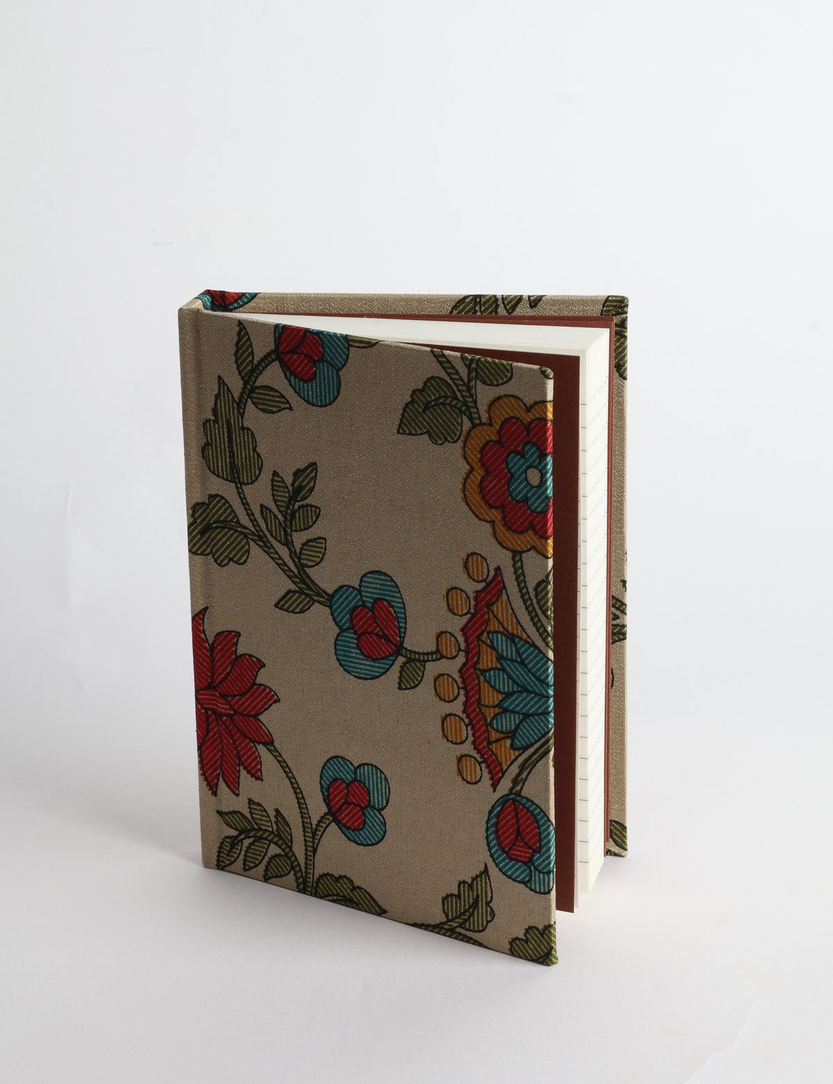 A6 hard cover notebook with teal pre-loved sari fabric cover featuring dark green floral vine pattern, standing upright