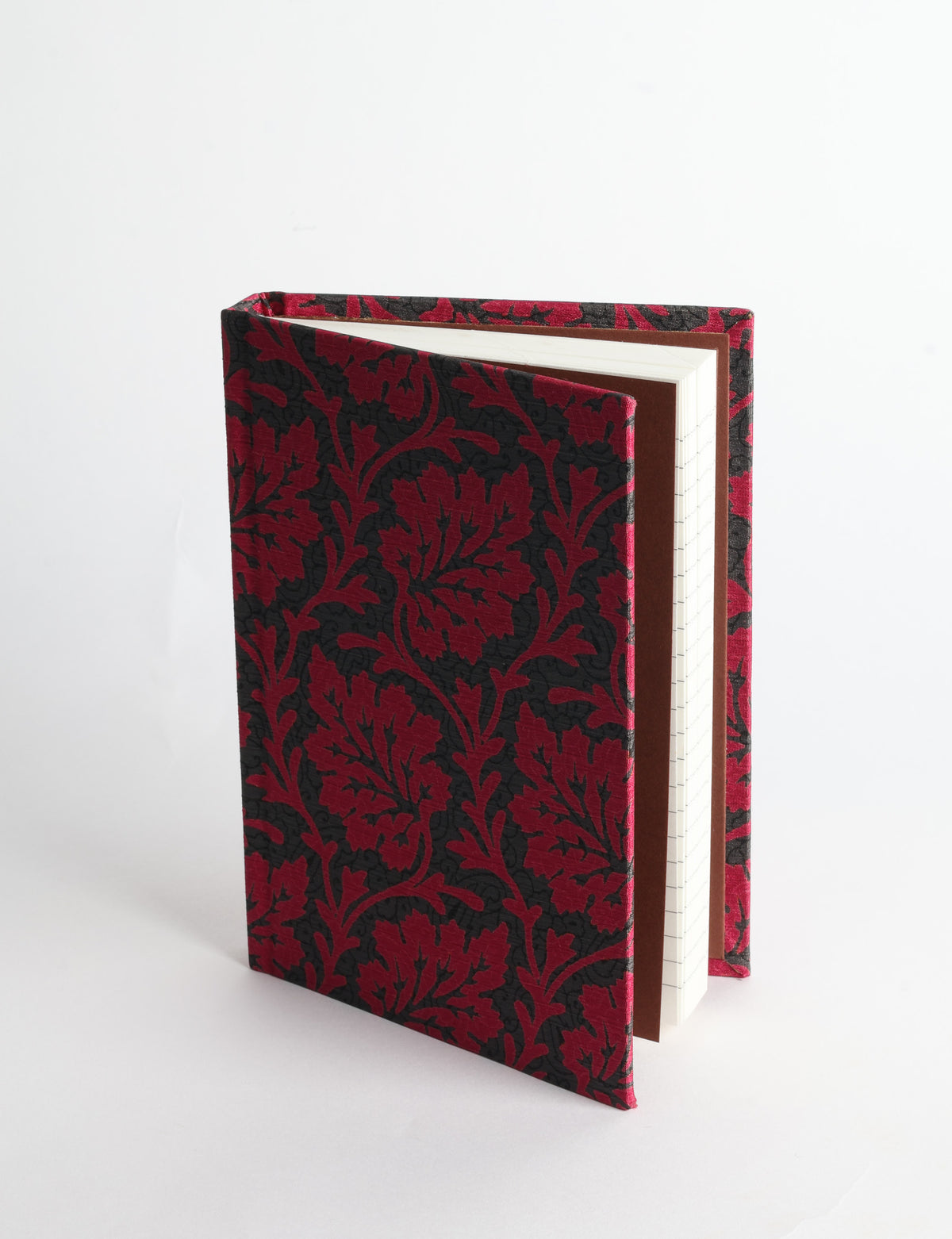 A6 hard cover notebook with teal pre-loved sari fabric cover featuring dark green floral vine pattern, standing upright