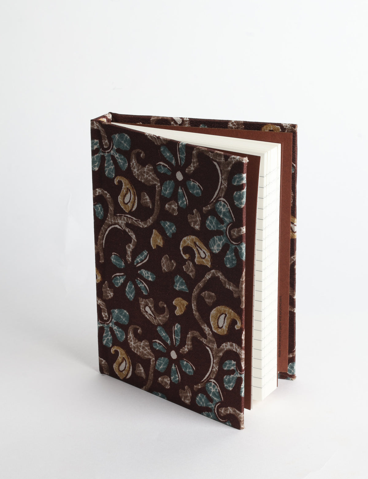 A6 hard cover notebook with teal pre-loved sari fabric cover featuring dark green floral vine pattern, standing upright