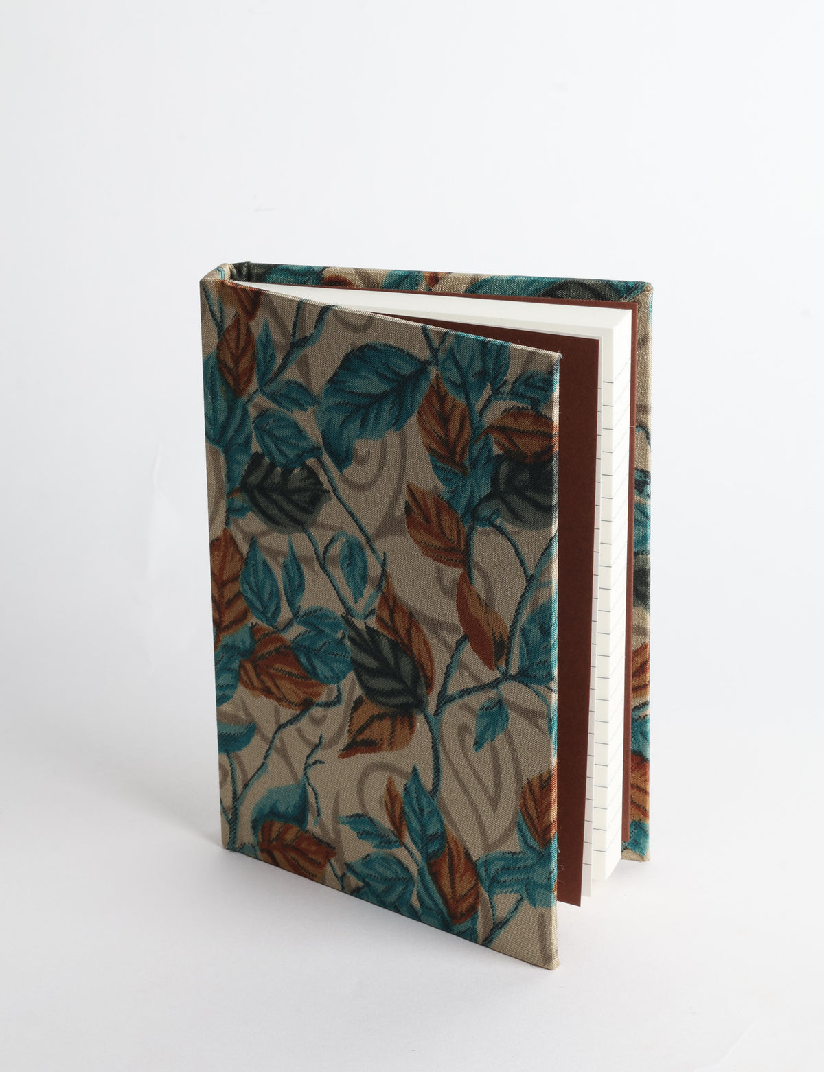 A6 hard cover notebook with teal pre-loved sari fabric cover featuring dark green floral vine pattern, standing upright
