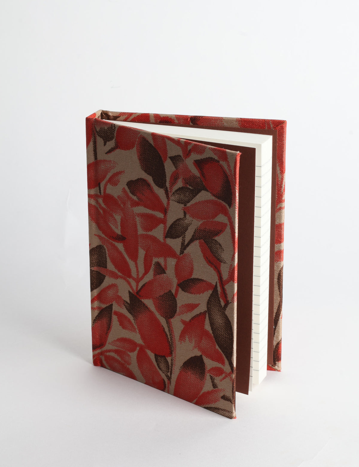 A6 hard cover notebook with teal pre-loved sari fabric cover featuring dark green floral vine pattern, standing upright