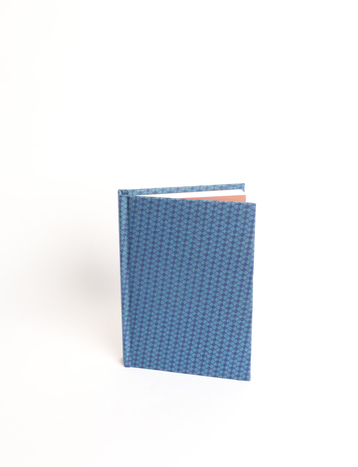 A6 hard cover notebook with teal pre-loved sari fabric cover featuring dark green floral vine pattern, standing upright