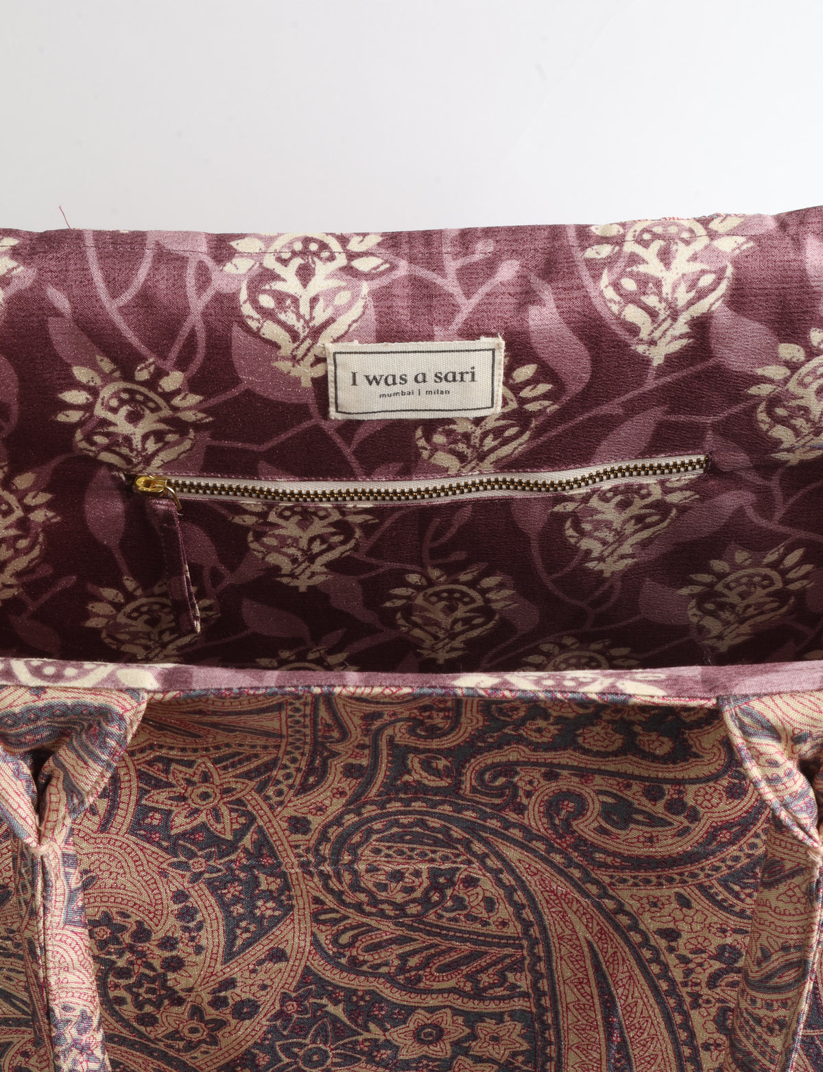 Grey floral fabric work tote bag with blue and beige flowers, teal interior lining with beige polka dots, and fabric handles