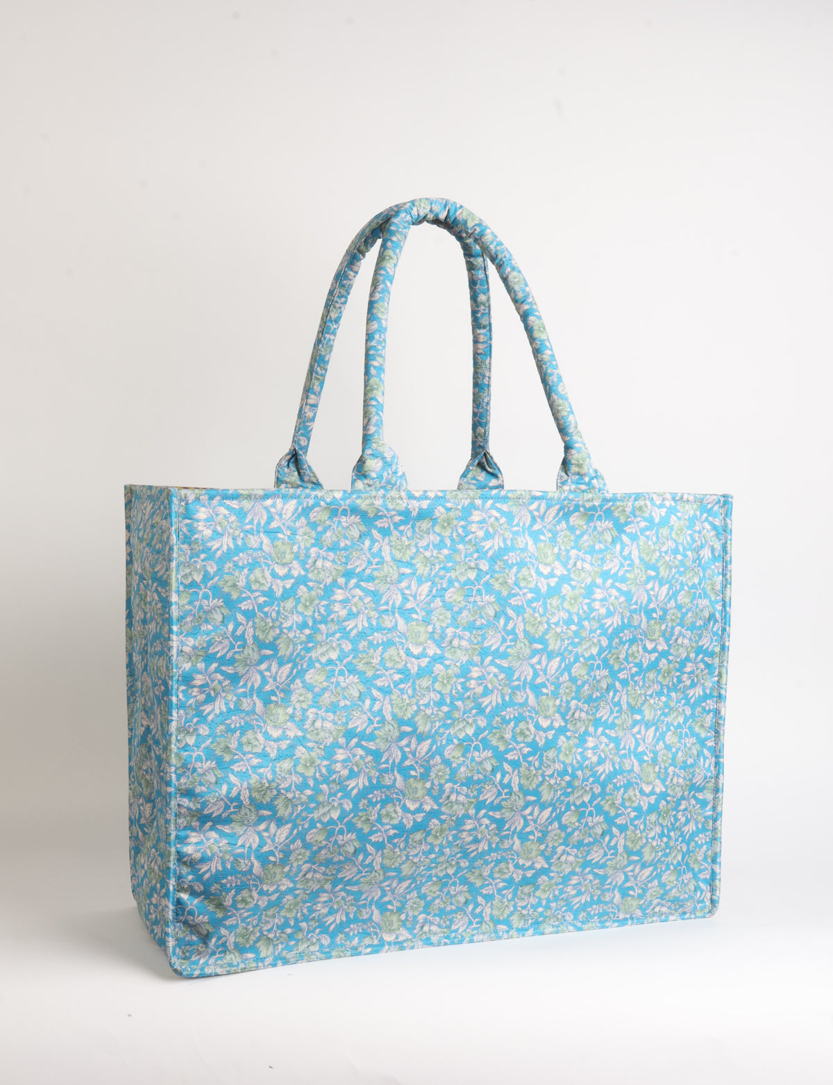 Grey floral patterned work tote bag with padded handles, front view, standing upright on white background