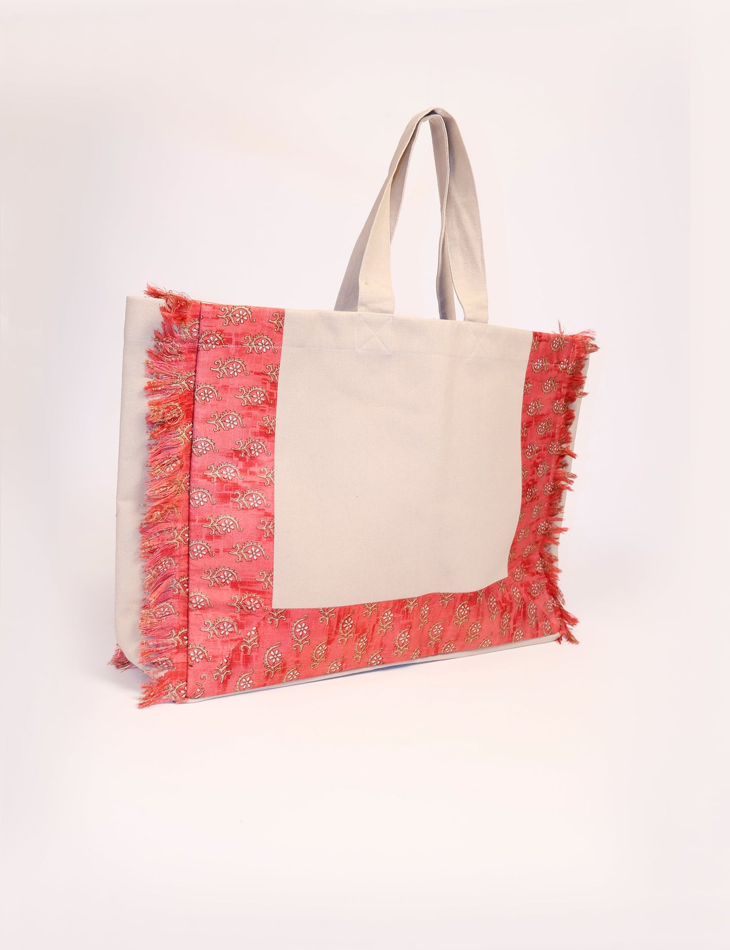 Lighten your eco-load with our FRINGE CARRY-ALL BAG. Soft canvas with a patchwork design, inside lining made of vibrant sari fabric, and beautifully soft sari-fringed edging. Crafted with 100% cotton canvas for a sustainable and stylish carry-all.