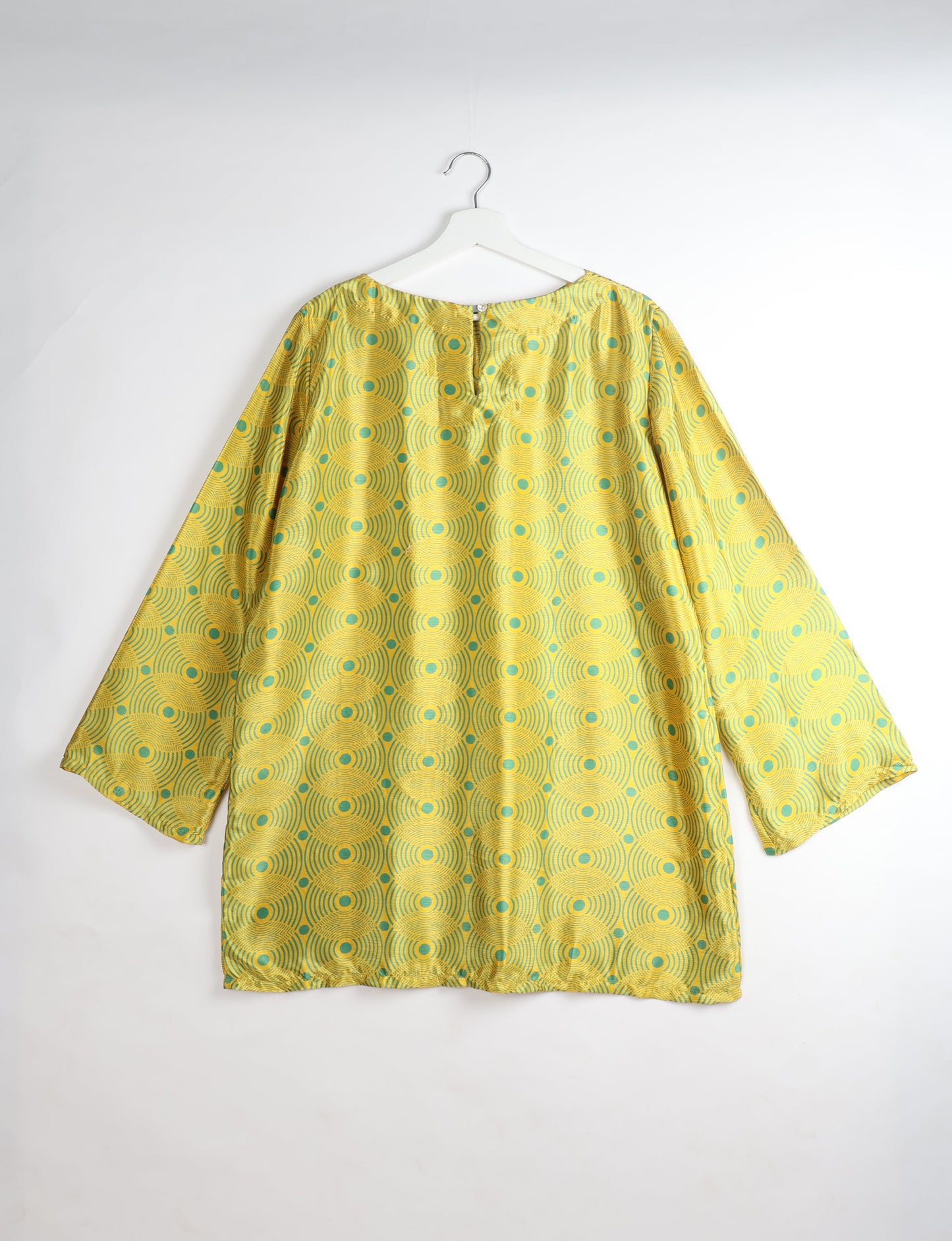 Chic and conscious, our A-line mini swing dress is a must-have in sustainable fashion. Adorned with flared sleeves, a keyhole back opening, and a mother of pearl button with twill tape loop. This zero waste, upcycled garment reflects the essence of eco-friendly and ethical clothing.