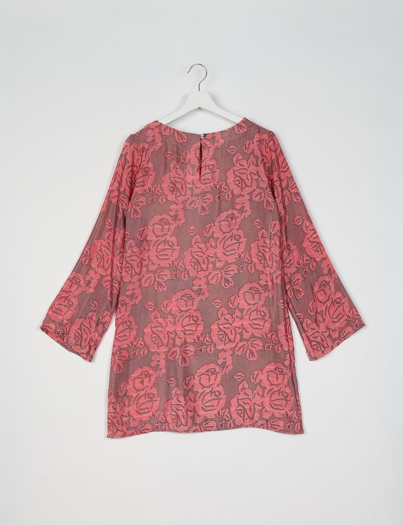 Grey swing dress with pink floral pattern, long sleeves, round neckline, and back button closure, hanging on white hanger