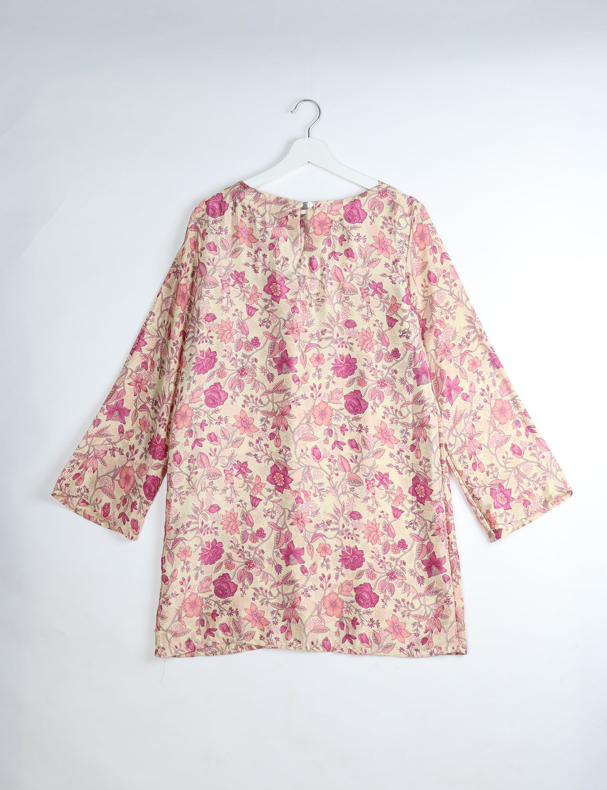 Long-sleeve floral print dress in pink and beige tones, shown from the back on a white hanger against a white background