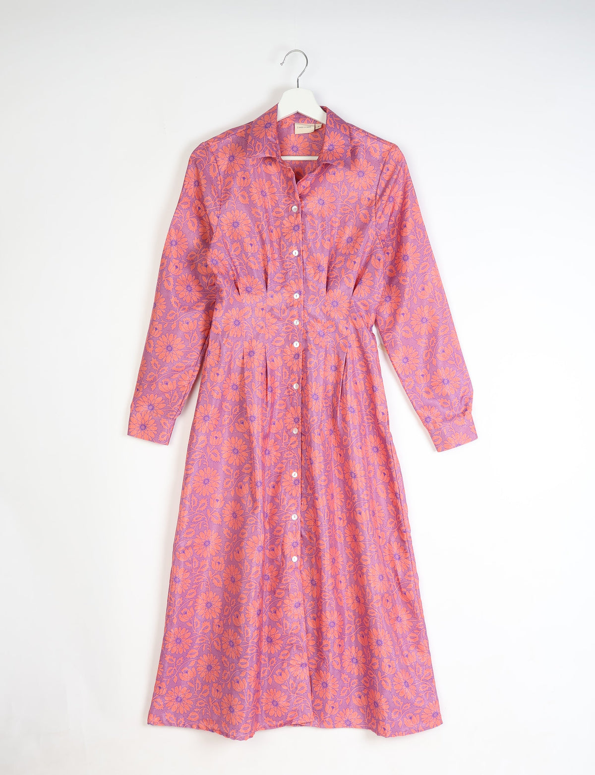 Purple midi shirt dress with orange floral pattern, long sleeves, button front, and collar, hanging on white hanger