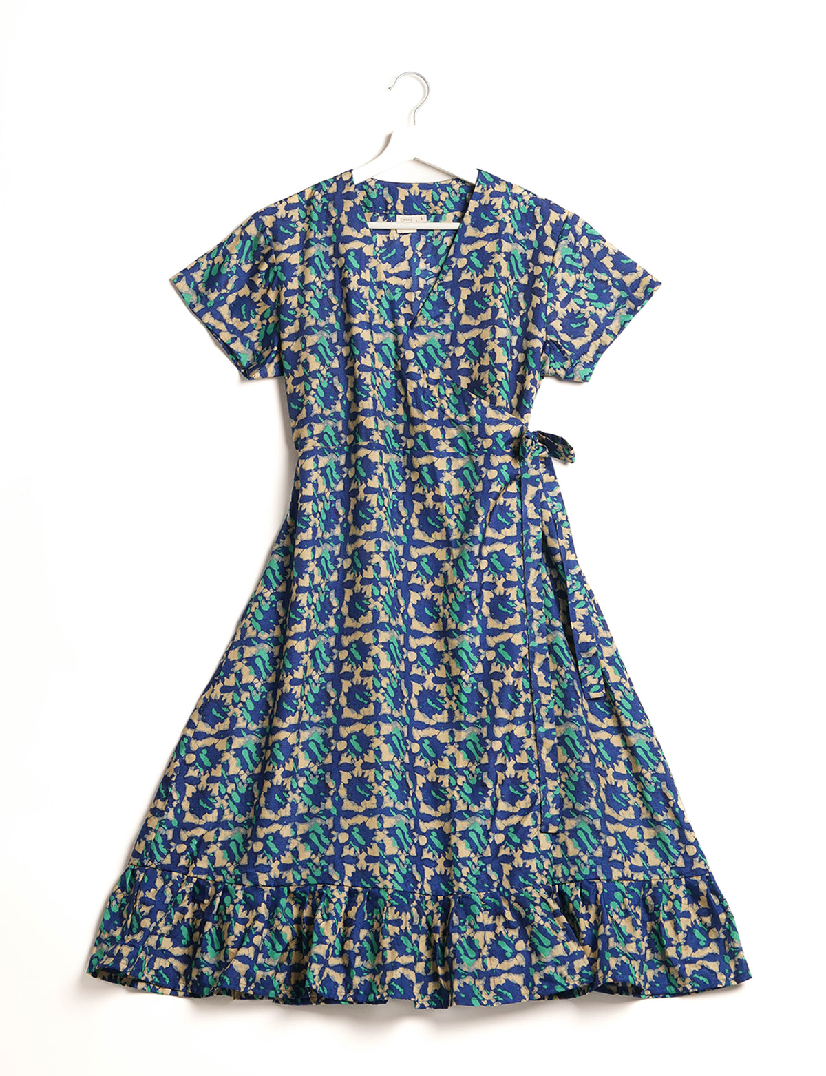Embrace timeless elegance with our MIDI WRAP DRESS – a midi-length beauty featuring a v-neck, flattery from all angles, and a charming sari belt. Crafted from sustainable materials, this dress embodies ethical clothing and green fashion. Sophisticated with a frill tier at the hem and short cap sleeves, this dress is perfect for any occasion. Tie up the beautifully crafted sari belt on the side for a versatile, stylish, and eco-friendly look.