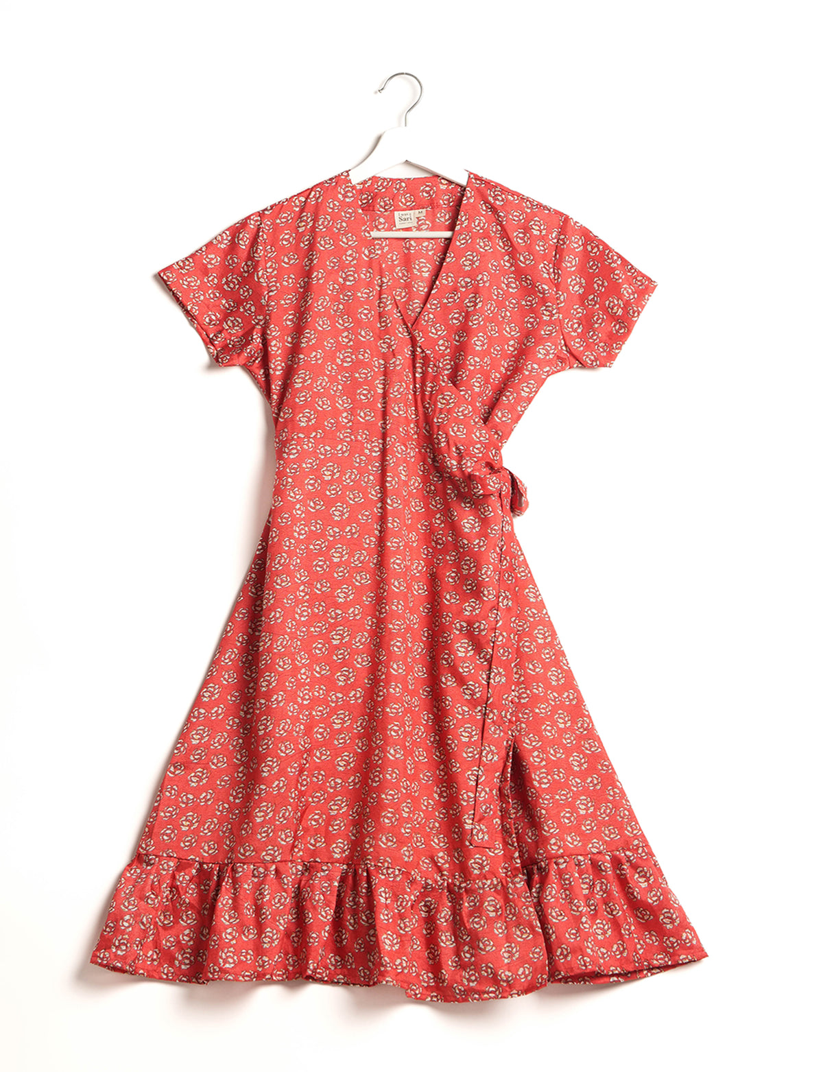 Embrace timeless elegance with our MIDI WRAP DRESS – a midi-length beauty featuring a v-neck, flattery from all angles, and a charming sari belt. Crafted from sustainable materials, this dress embodies ethical clothing and green fashion. Sophisticated with a frill tier at the hem and short cap sleeves, this dress is perfect for any occasion. Tie up the beautifully crafted sari belt on the side for a versatile, stylish, and eco-friendly look.