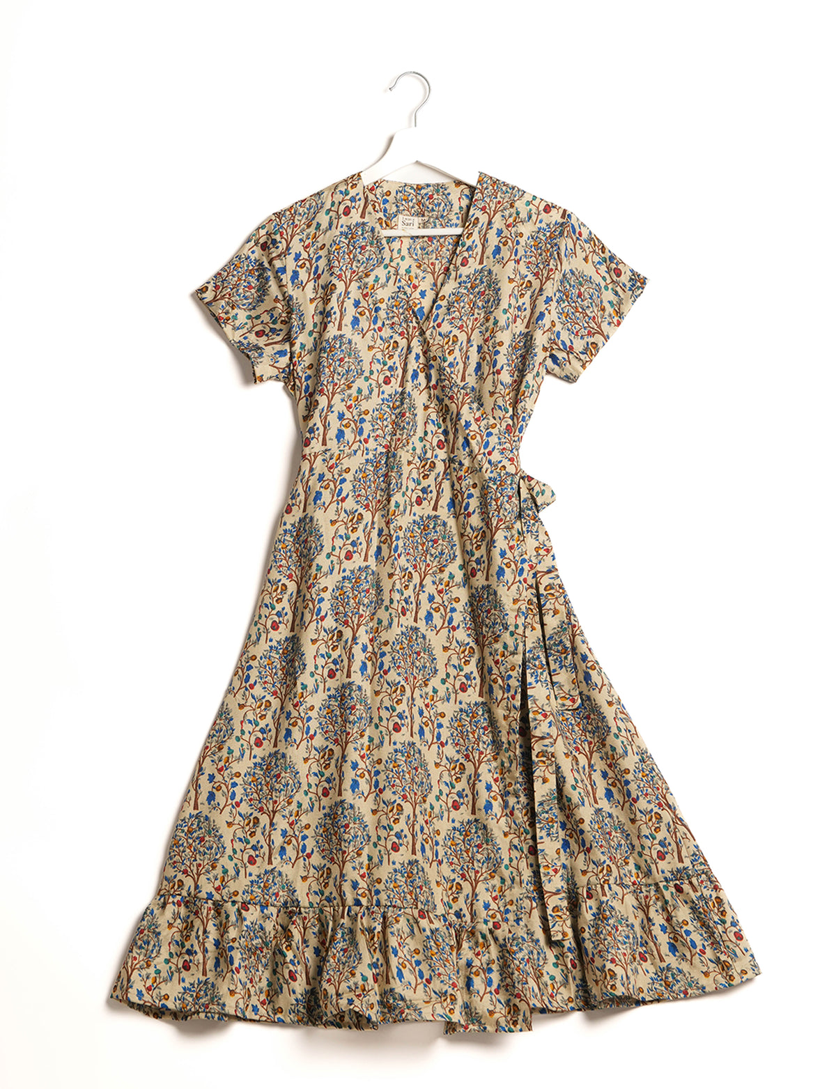 Embrace timeless elegance with our MIDI WRAP DRESS – a midi-length beauty featuring a v-neck, flattery from all angles, and a charming sari belt. Crafted from sustainable materials, this dress embodies ethical clothing and green fashion. Sophisticated with a frill tier at the hem and short cap sleeves, this dress is perfect for any occasion. Tie up the beautifully crafted sari belt on the side for a versatile, stylish, and eco-friendly look.