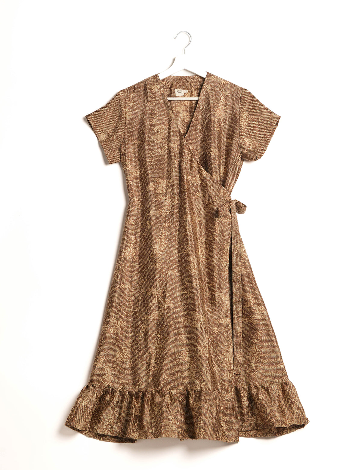 Embrace timeless elegance with our MIDI WRAP DRESS – a midi-length beauty featuring a v-neck, flattery from all angles, and a charming sari belt. Crafted from sustainable materials, this dress embodies ethical clothing and green fashion. Sophisticated with a frill tier at the hem and short cap sleeves, this dress is perfect for any occasion. Tie up the beautifully crafted sari belt on the side for a versatile, stylish, and eco-friendly look.