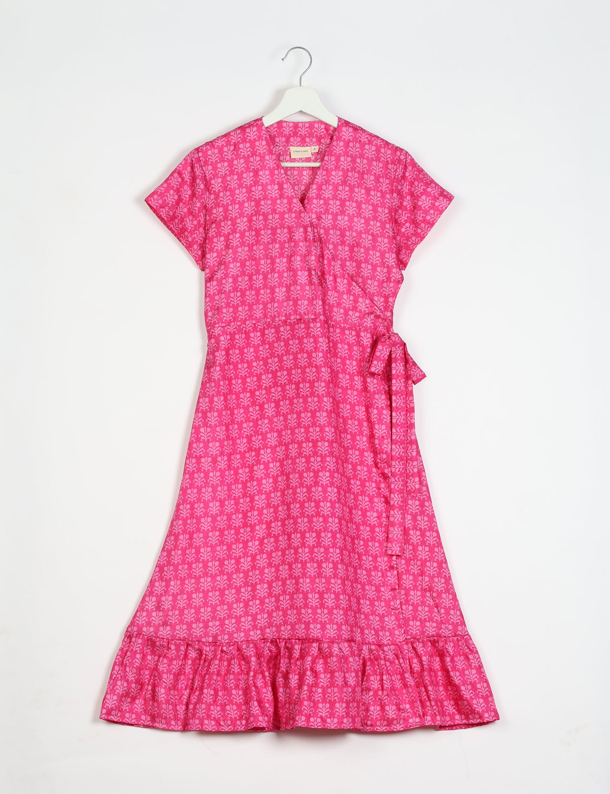 Embrace timeless elegance with our MIDI WRAP DRESS – a midi-length beauty featuring a v-neck, flattery from all angles, and a charming sari belt. Crafted from sustainable materials, this dress embodies ethical clothing and green fashion. Sophisticated with a frill tier at the hem and short cap sleeves, this dress is perfect for any occasion. Tie up the beautifully crafted sari belt on the side for a versatile, stylish, and eco-friendly look.