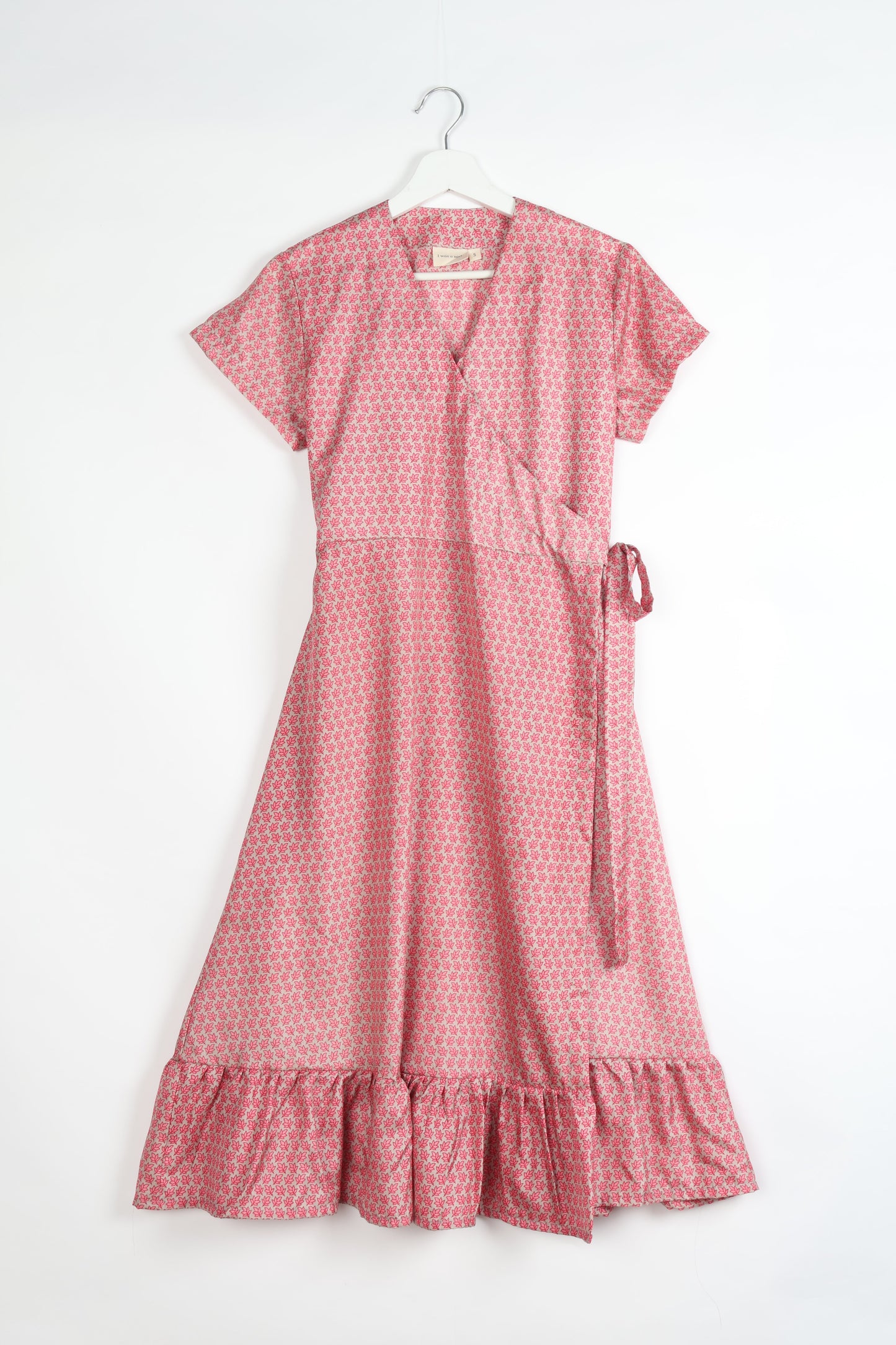 Embrace timeless elegance with our MIDI WRAP DRESS – a midi-length beauty featuring a v-neck, flattery from all angles, and a charming sari belt. Crafted from sustainable materials, this dress embodies ethical clothing and green fashion. Sophisticated with a frill tier at the hem and short cap sleeves, this dress is perfect for any occasion. Tie up the beautifully crafted sari belt on the side for a versatile, stylish, and eco-friendly look.