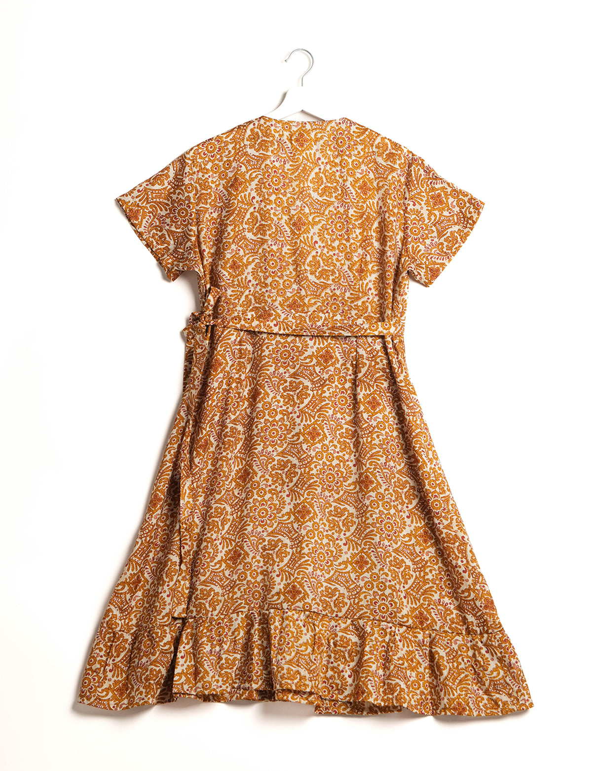 Embrace timeless elegance with our MIDI WRAP DRESS – a midi-length beauty featuring a v-neck, flattery from all angles, and a charming sari belt. Crafted from sustainable materials, this dress embodies ethical clothing and green fashion. Sophisticated with a frill tier at the hem and short cap sleeves, this dress is perfect for any occasion. Tie up the beautifully crafted sari belt on the side for a versatile, stylish, and eco-friendly look.