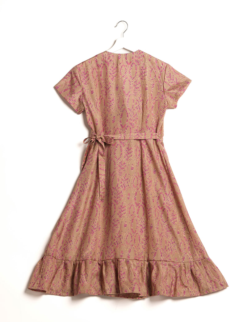 Beige midi wrap dress with pink leaf pattern, short sleeves, side tie, and ruffled hem, shown from back on hanger