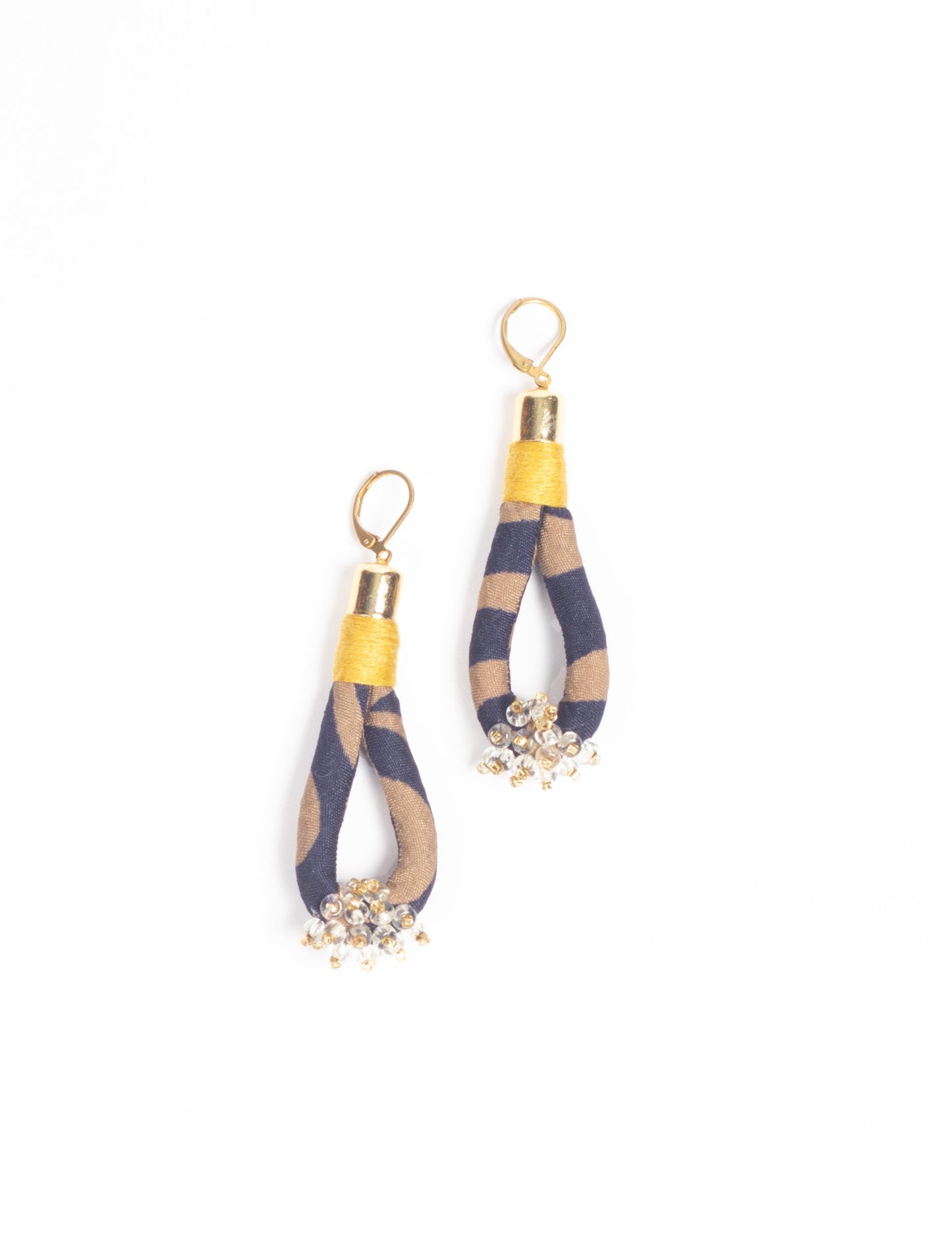 Discover the charm of Beaded Drop Earrings, meticulously crafted by Indian artisans. Recycled cotton rope, sari fabric, and surplus glass beads create an eco-friendly masterpiece. Hypoallergenic metal hooks ensure both style and comfort.