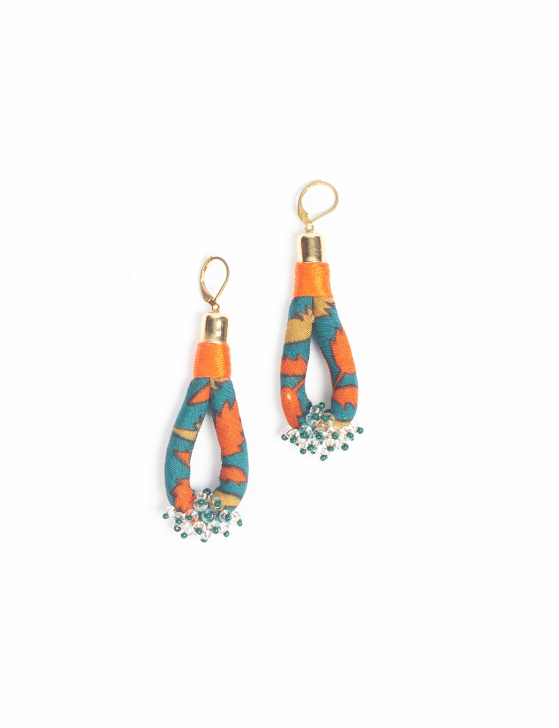 Beaded drop earrings with green tropical pattern fabric, orange thread wrap, gold-tone hooks, and small bead clusters at the bottom