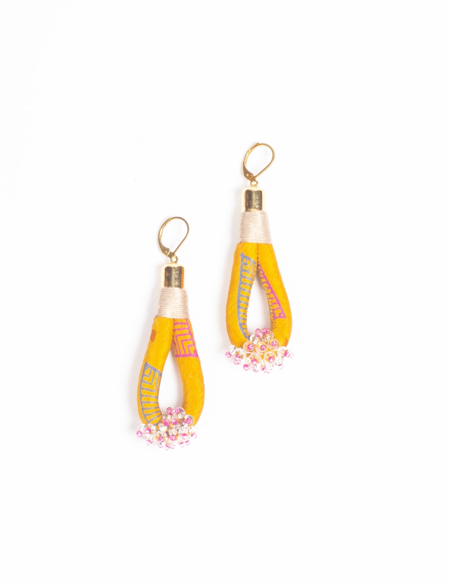 Discover the charm of Beaded Drop Earrings, meticulously crafted by Indian artisans. Recycled cotton rope, sari fabric, and surplus glass beads create an eco-friendly masterpiece. Hypoallergenic metal hooks ensure both style and comfort.