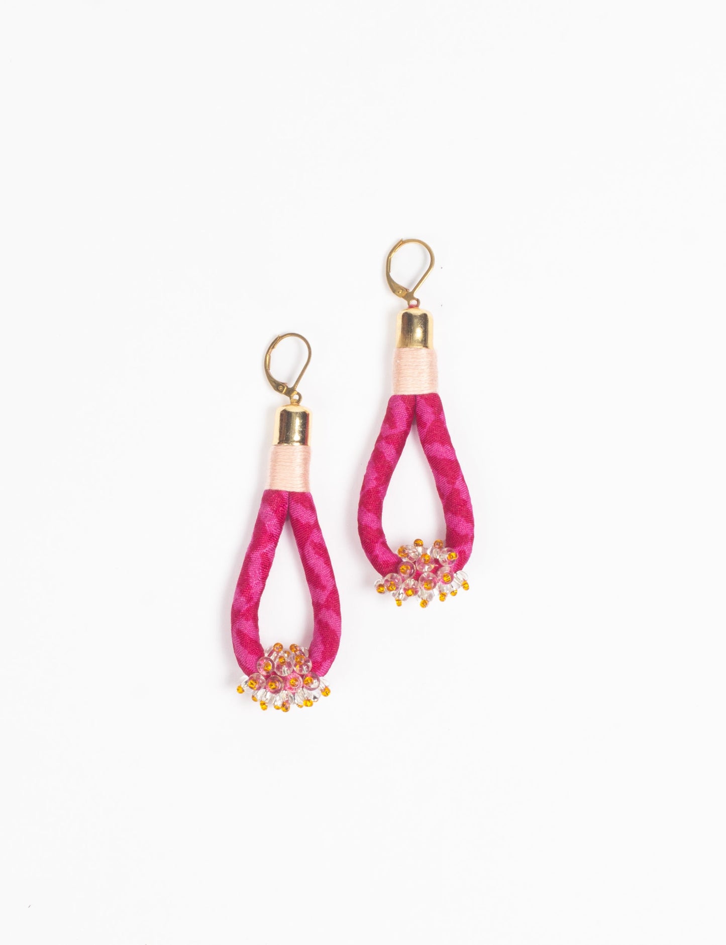 Discover the charm of Beaded Drop Earrings, meticulously crafted by Indian artisans. Recycled cotton rope, sari fabric, and surplus glass beads create an eco-friendly masterpiece. Hypoallergenic metal hooks ensure both style and comfort.