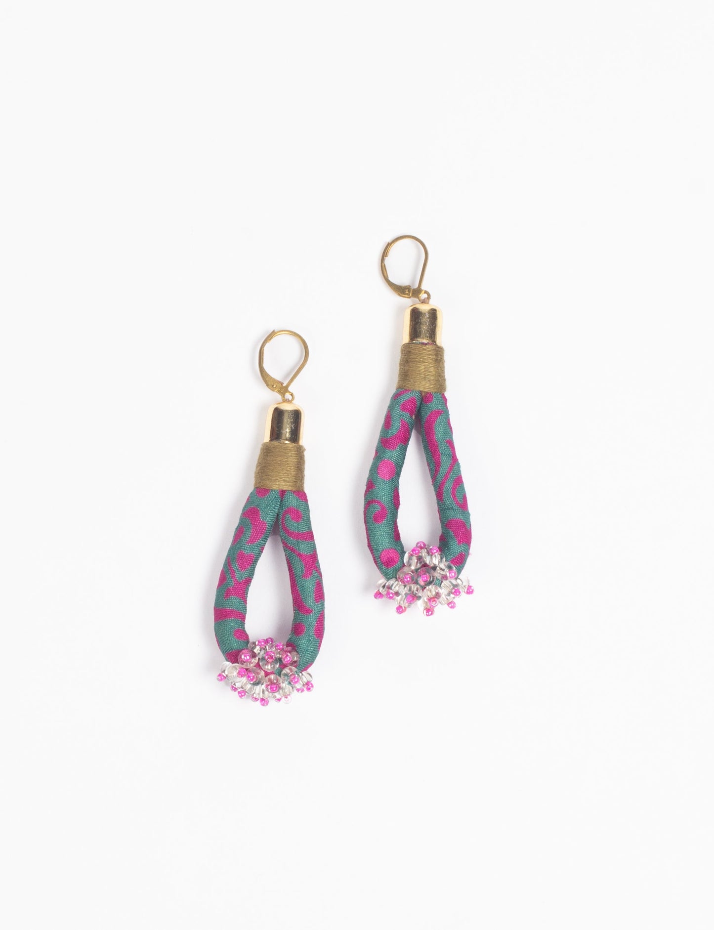 Discover the charm of Beaded Drop Earrings, meticulously crafted by Indian artisans. Recycled cotton rope, sari fabric, and surplus glass beads create an eco-friendly masterpiece. Hypoallergenic metal hooks ensure both style and comfort.