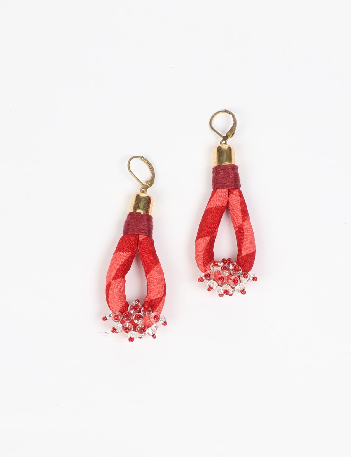 Red geometric beaded drop earrings with gold-tone hooks and fabric wrapped loops, 8 cm length, flat lay on white background