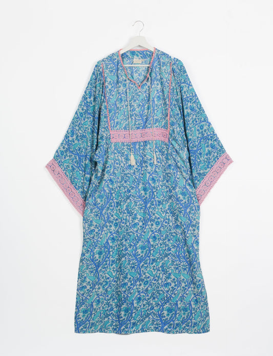 Maxi Kaftan with cotton lace on sleeves and midriff, featuring a tie-up neckline with tassels. Ankle-length, eco-friendly fashion made from recycled materials, offering sustainable women’s clothing for a chic, earth-friendly wardrobe.