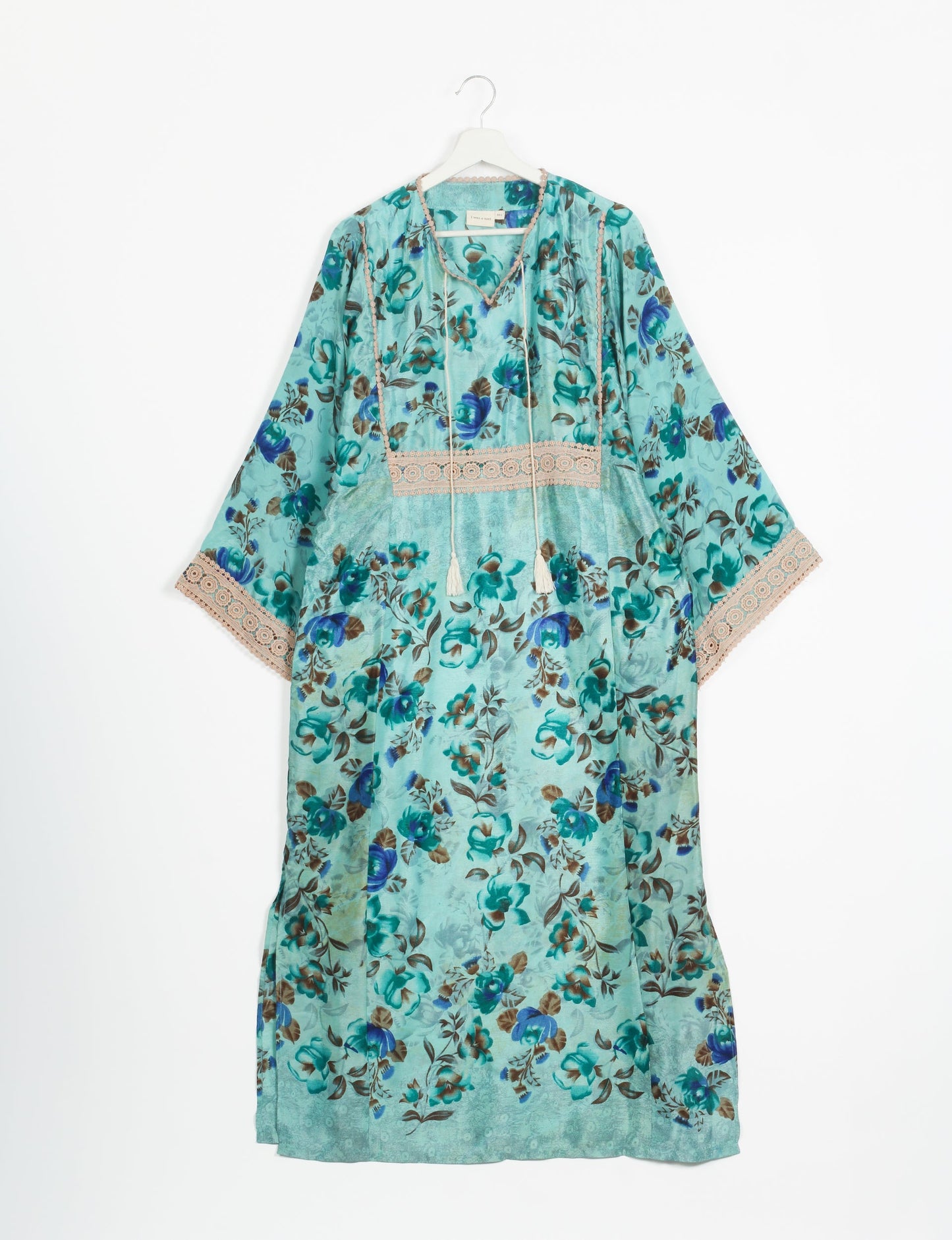 Maxi Kaftan with cotton lace on sleeves and midriff, featuring a tie-up neckline with tassels. Ankle-length, eco-friendly fashion made from recycled materials, offering sustainable women’s clothing for a chic, earth-friendly wardrobe.