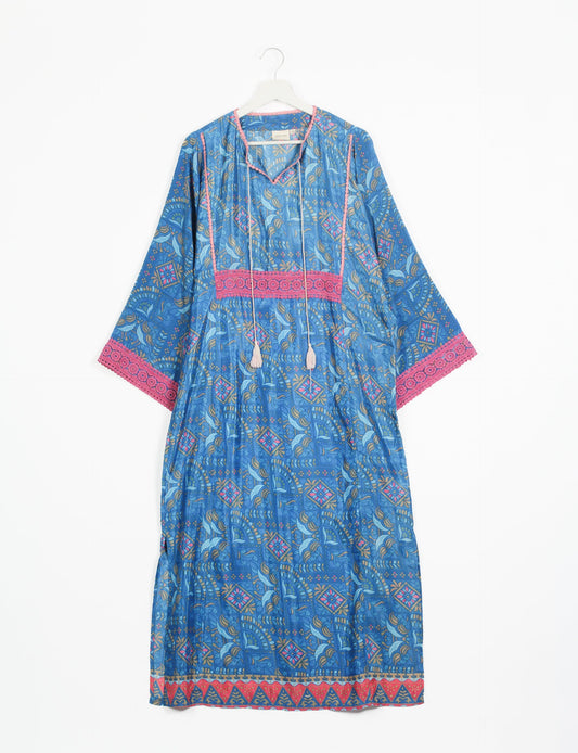 Maxi Kaftan with cotton lace on sleeves and midriff, featuring a tie-up neckline with tassels. Ankle-length, eco-friendly fashion made from recycled materials, offering sustainable women’s clothing for a chic, earth-friendly wardrobe.