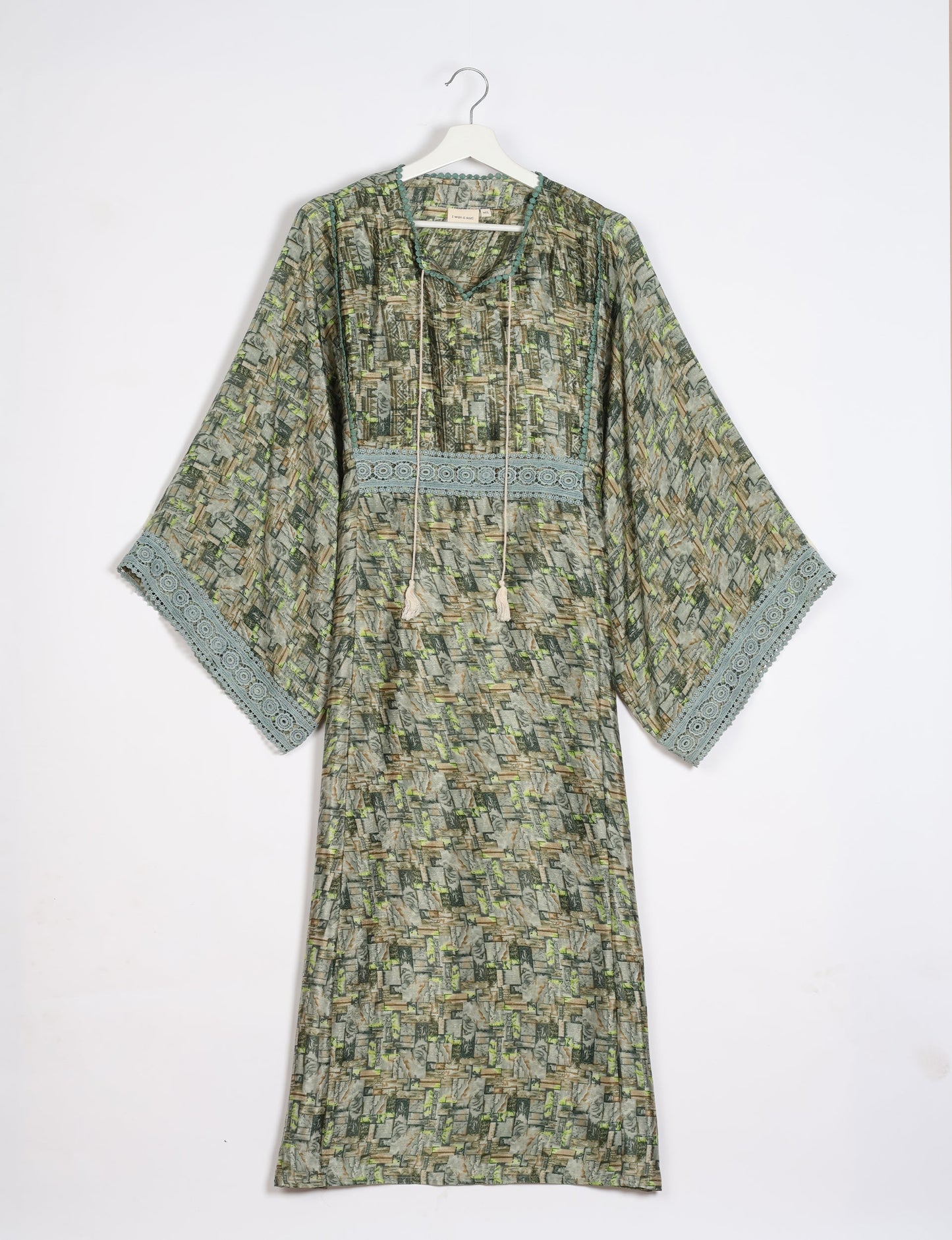 Maxi Kaftan with cotton lace on sleeves and midriff, featuring a tie-up neckline with tassels. Ankle-length, eco-friendly fashion made from recycled materials, offering sustainable women’s clothing for a chic, earth-friendly wardrobe.