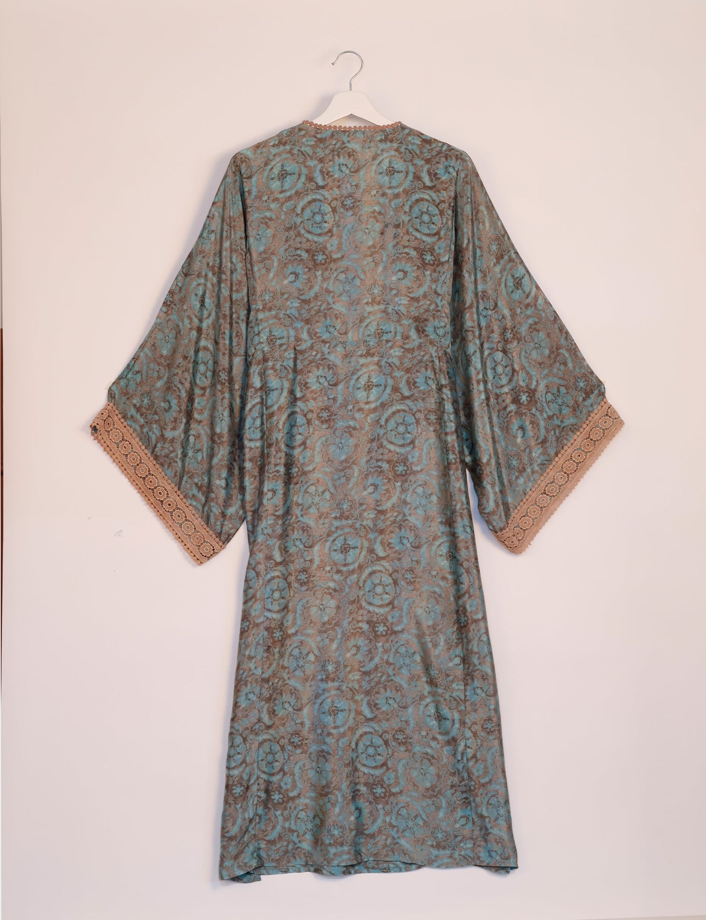 Maxi Kaftan with cotton lace on sleeves and midriff, featuring a tie-up neckline with tassels. Ankle-length, eco-friendly fashion made from recycled materials, offering sustainable women’s clothing for a chic, earth-friendly wardrobe.