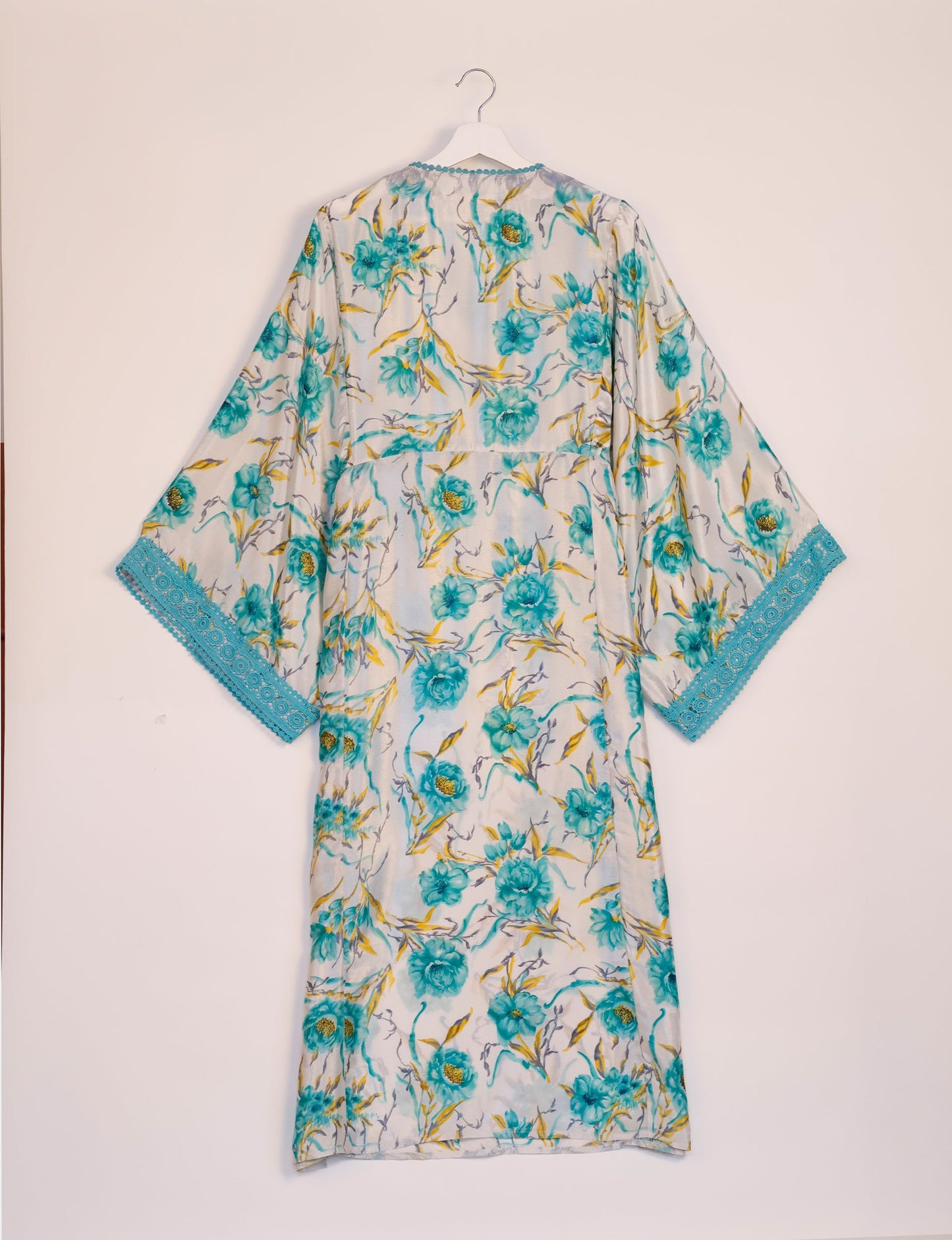 Maxi Kaftan with cotton lace on sleeves and midriff, featuring a tie-up neckline with tassels. Ankle-length, eco-friendly fashion made from recycled materials, offering sustainable women’s clothing for a chic, earth-friendly wardrobe.