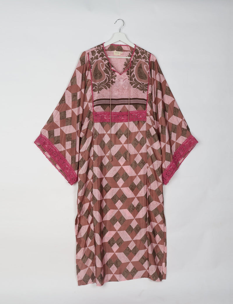 Brown and pink geometric patterned maxi kaftan with V-neck, tassel ties, and pink lace trim on sleeves, hanging on white hanger
