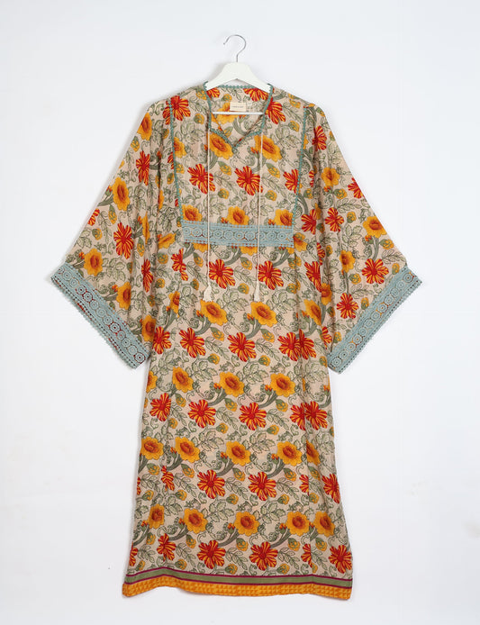 Maxi Kaftan with cotton lace on sleeves and midriff, featuring a tie-up neckline with tassels. Ankle-length, eco-friendly fashion made from recycled materials, offering sustainable women’s clothing for a chic, earth-friendly wardrobe.