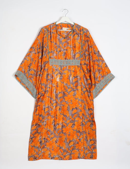 Maxi Kaftan with cotton lace on sleeves and midriff, featuring a tie-up neckline with tassels. Ankle-length, eco-friendly fashion made from recycled materials, offering sustainable women’s clothing for a chic, earth-friendly wardrobe.