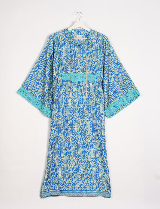 Maxi Kaftan with cotton lace on sleeves and midriff, featuring a tie-up neckline with tassels. Ankle-length, eco-friendly fashion made from recycled materials, offering sustainable women’s clothing for a chic, earth-friendly wardrobe.