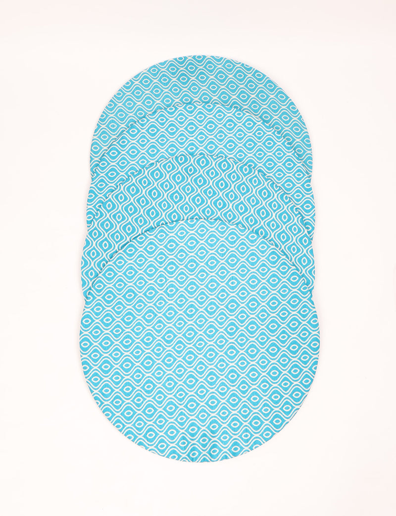 Set of four round blue placemats with white abstract geometric pattern, shown stacked flat on white background