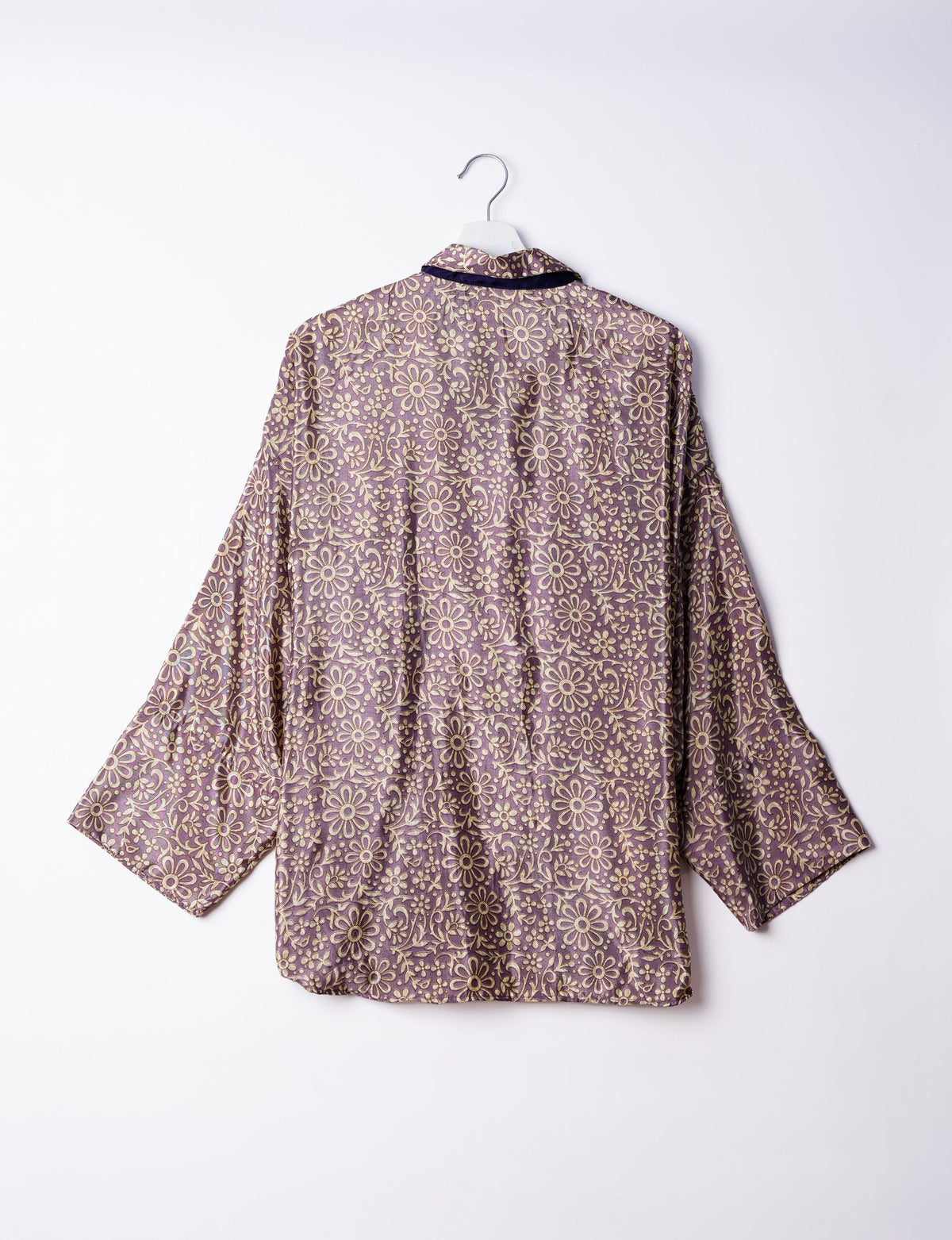 Experience chic comfort with our OVERSIZED SHIRT – a one-of-a-kind piece crafted from sari waste by talented Indian female artisans. With 3/4 length sleeves, a regular shirt collar, and a contrasting inner collar band, this shirt is perfect for work or casual hangouts. Versatile and stylish, it pairs effortlessly over a shift dress, jumpsuit, or with pants.