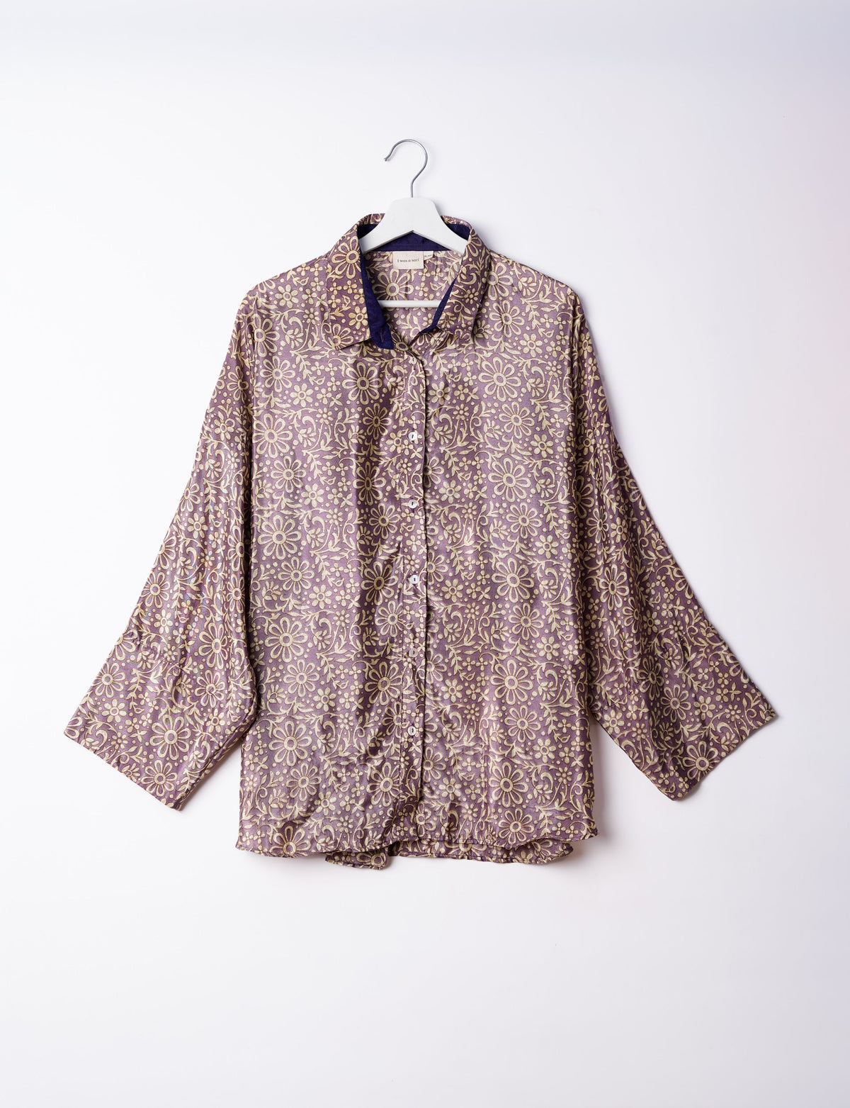 Experience chic comfort with our OVERSIZED SHIRT – a one-of-a-kind piece crafted from sari waste by talented Indian female artisans. With 3/4 length sleeves, a regular shirt collar, and a contrasting inner collar band, this shirt is perfect for work or casual hangouts. Versatile and stylish, it pairs effortlessly over a shift dress, jumpsuit, or with pants.