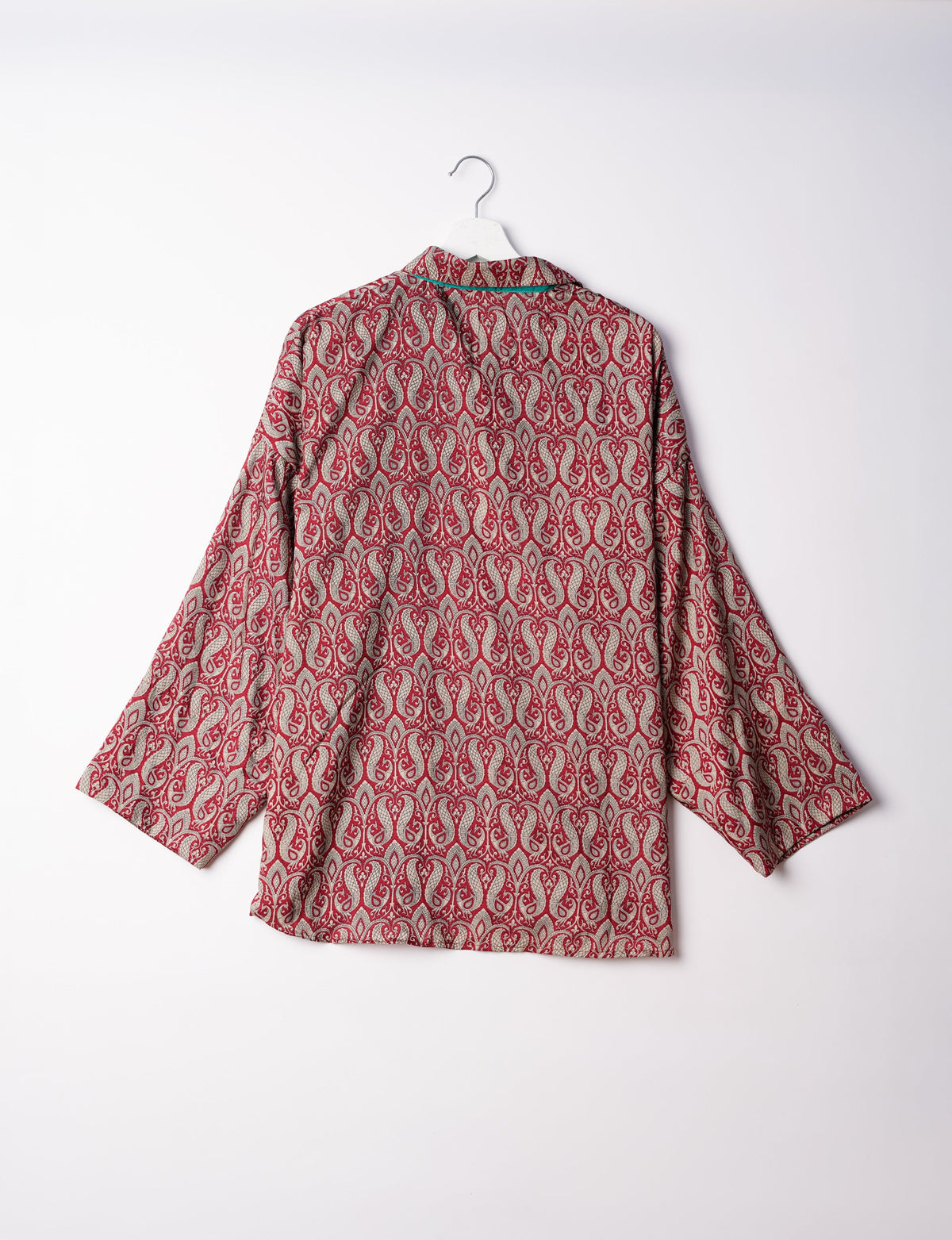 Experience chic comfort with our OVERSIZED SHIRT – a one-of-a-kind piece crafted from sari waste by talented Indian female artisans. With 3/4 length sleeves, a regular shirt collar, and a contrasting inner collar band, this shirt is perfect for work or casual hangouts. Versatile and stylish, it pairs effortlessly over a shift dress, jumpsuit, or with pants.