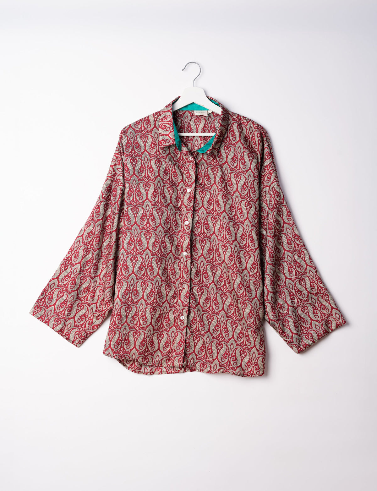 Experience chic comfort with our OVERSIZED SHIRT – a one-of-a-kind piece crafted from sari waste by talented Indian female artisans. With 3/4 length sleeves, a regular shirt collar, and a contrasting inner collar band, this shirt is perfect for work or casual hangouts. Versatile and stylish, it pairs effortlessly over a shift dress, jumpsuit, or with pants.