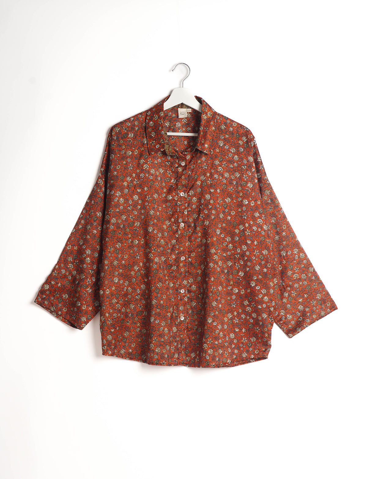 Experience chic comfort with our OVERSIZED SHIRT – a one-of-a-kind piece crafted from sari waste by talented Indian female artisans. With 3/4 length sleeves, a regular shirt collar, and a contrasting inner collar band, this shirt is perfect for work or casual hangouts. Versatile and stylish, it pairs effortlessly over a shift dress, jumpsuit, or with pants.