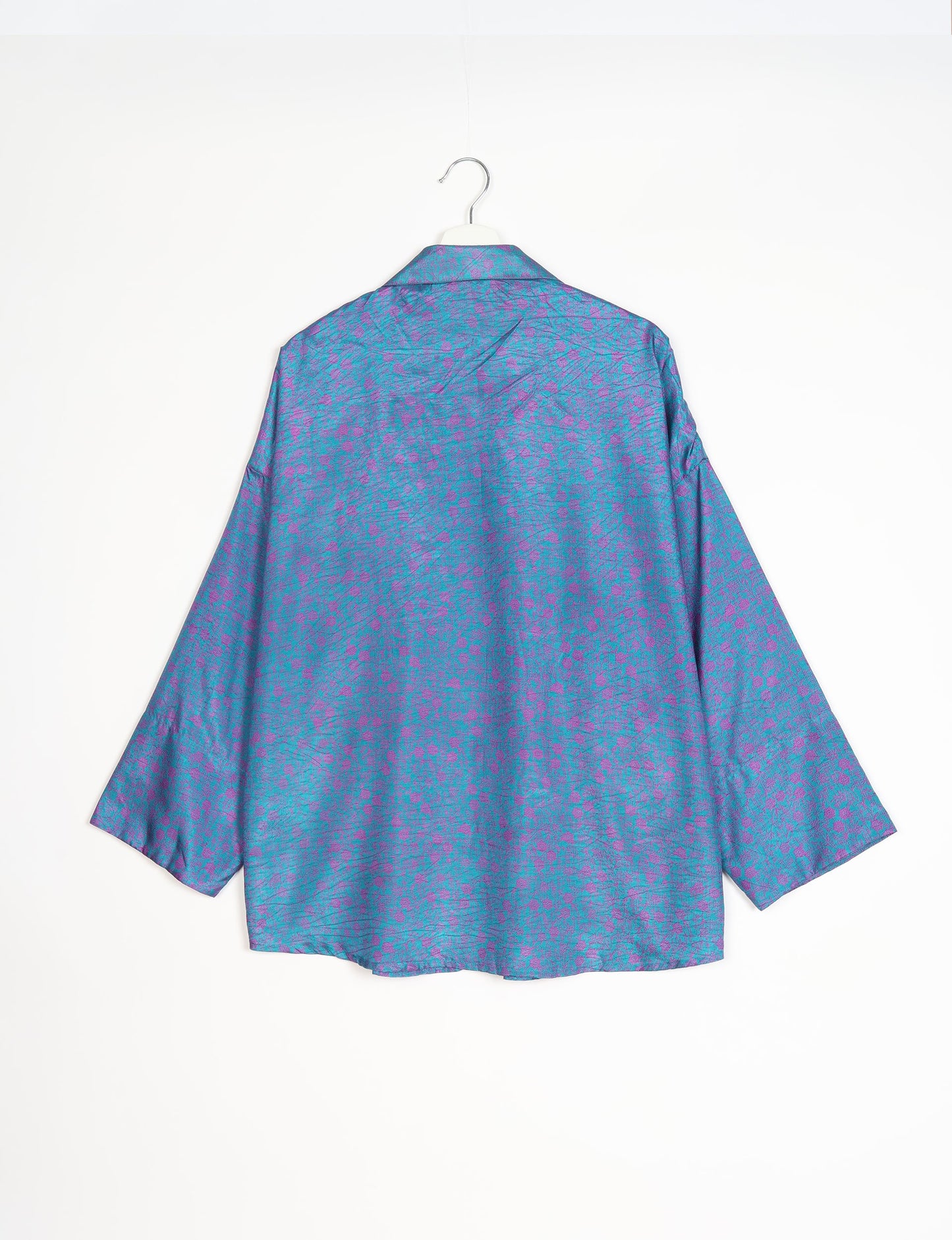 Experience chic comfort with our OVERSIZED SHIRT – a one-of-a-kind piece crafted from sari waste by talented Indian female artisans. With 3/4 length sleeves, a regular shirt collar, and a contrasting inner collar band, this shirt is perfect for work or casual hangouts. Versatile and stylish, it pairs effortlessly over a shift dress, jumpsuit, or with pants.