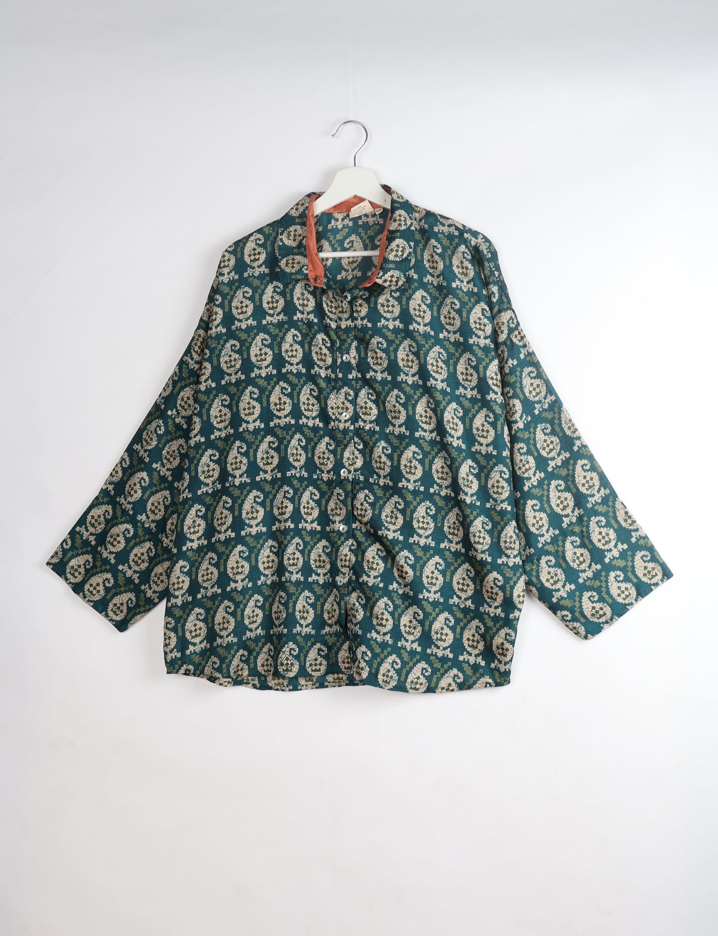 Experience chic comfort with our OVERSIZED SHIRT – a one-of-a-kind piece crafted from sari waste by talented Indian female artisans. With 3/4 length sleeves, a regular shirt collar, and a contrasting inner collar band, this shirt is perfect for work or casual hangouts. Versatile and stylish, it pairs effortlessly over a shift dress, jumpsuit, or with pants.