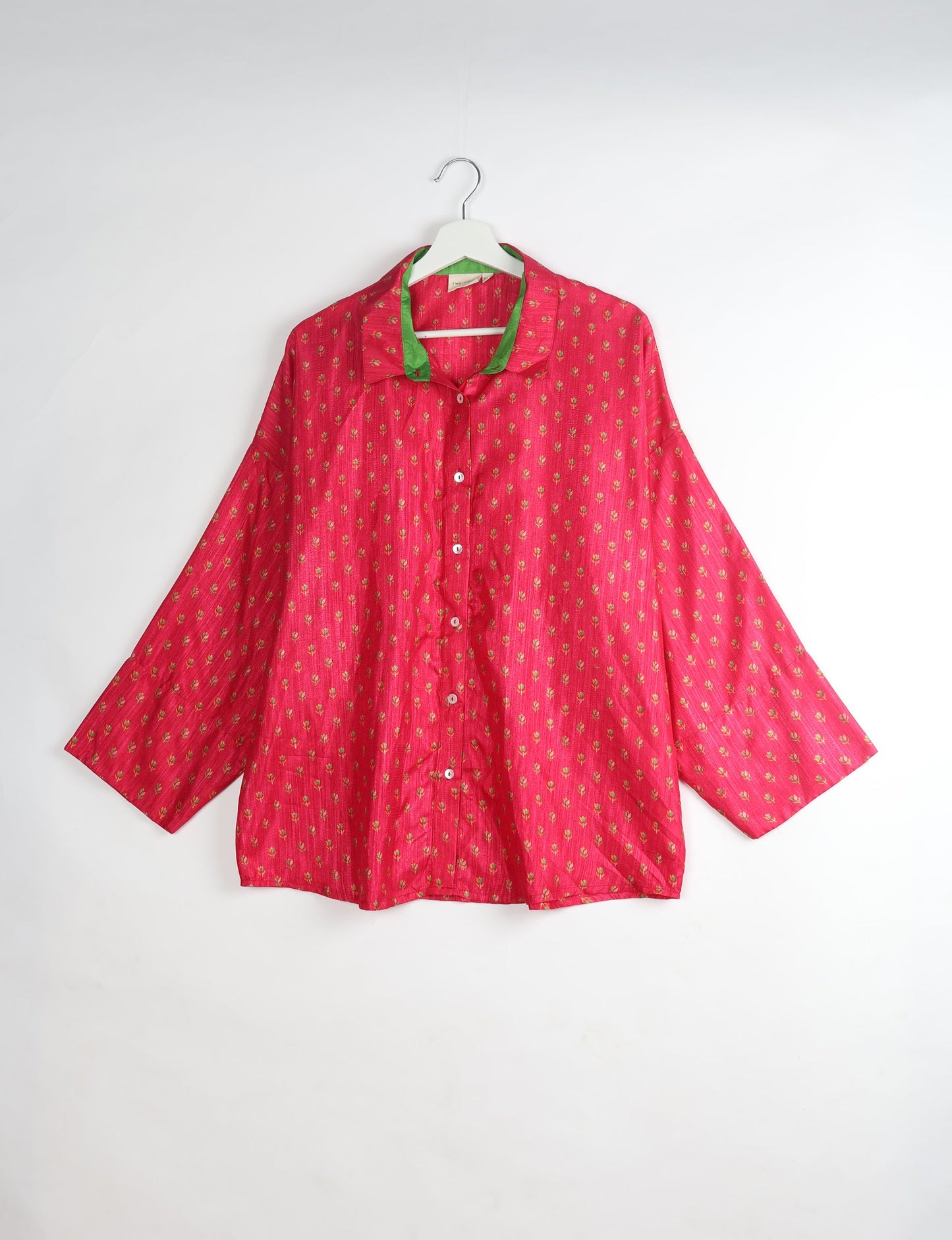 Experience chic comfort with our OVERSIZED SHIRT – a one-of-a-kind piece crafted from sari waste by talented Indian female artisans. With 3/4 length sleeves, a regular shirt collar, and a contrasting inner collar band, this shirt is perfect for work or casual hangouts. Versatile and stylish, it pairs effortlessly over a shift dress, jumpsuit, or with pants.