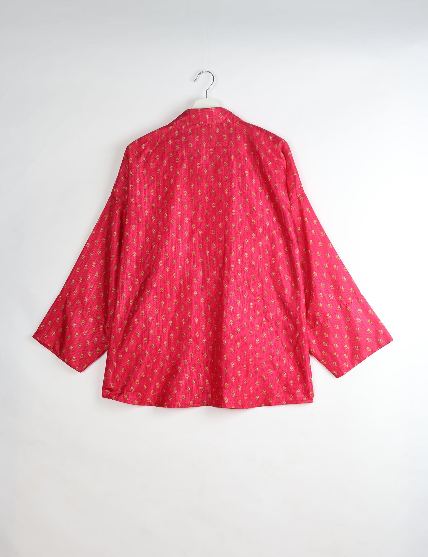 Experience chic comfort with our OVERSIZED SHIRT – a one-of-a-kind piece crafted from sari waste by talented Indian female artisans. With 3/4 length sleeves, a regular shirt collar, and a contrasting inner collar band, this shirt is perfect for work or casual hangouts. Versatile and stylish, it pairs effortlessly over a shift dress, jumpsuit, or with pants.